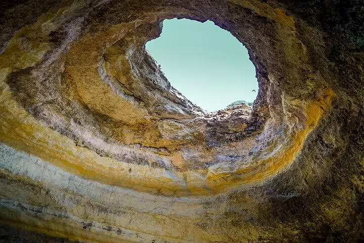 Stunning view of the Benagil caves' natural skylight on a private Algarve boat tour from Lisbon, showcasing unique geological formations.