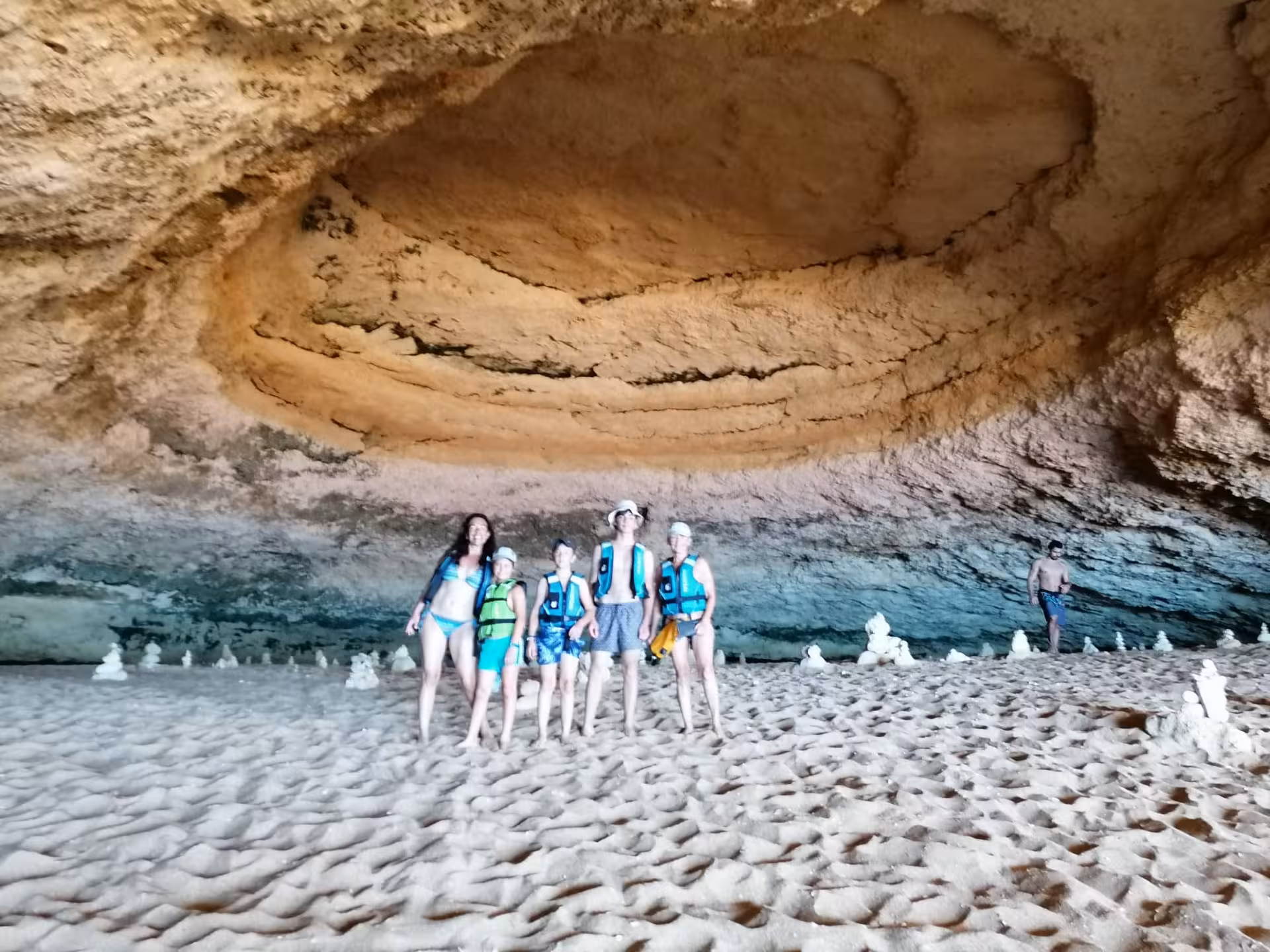 Group in life jackets on Benagil Cave beach, Algarve, during Benagil kayak rental sea cave tour