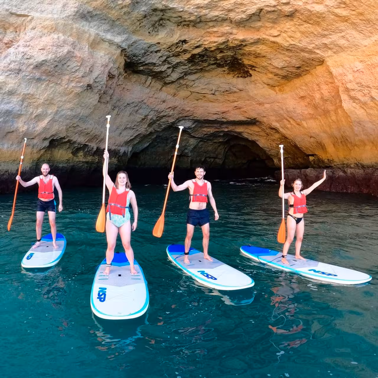 Group enjoying Benagil kayak rental under stunning sea cave, perfect for adventure seekers in Algarve.