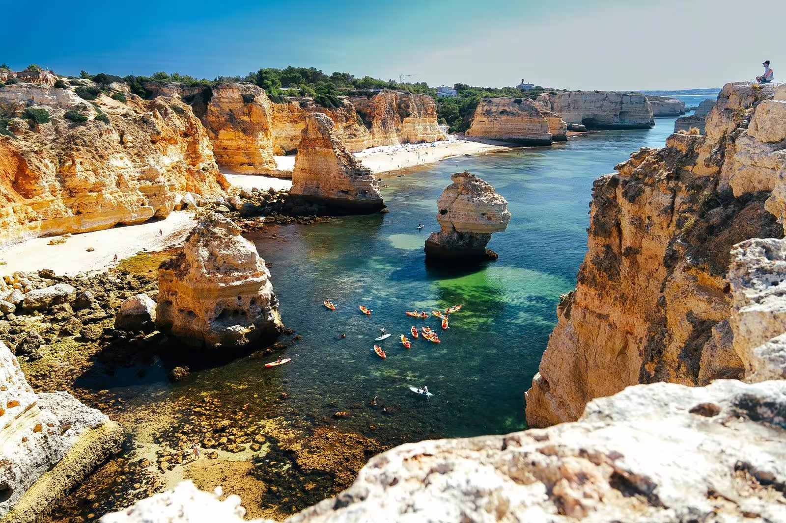 Aerial view of kayakers exploring Benagil's turquoise waters and majestic cliffs on a guided small group tour.