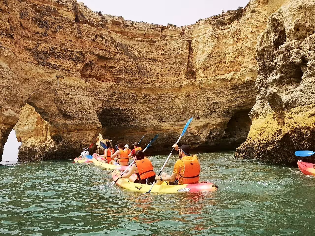 Group kayaking through stunning caves on Benagil Kayak Tour with expert local guides and small group experience.