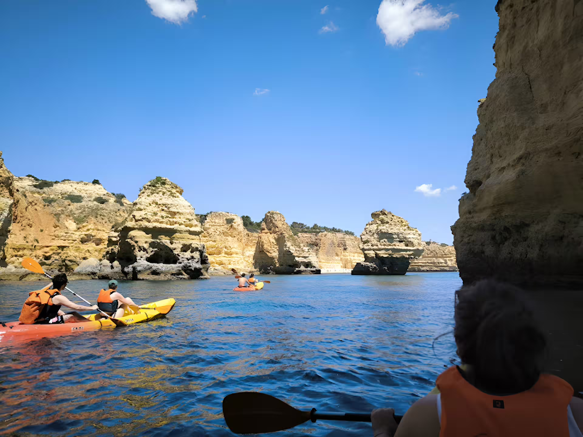Kayakers explore stunning cliffs on a Benagil kayak tour with a local guide, offering small groups and quality gear.