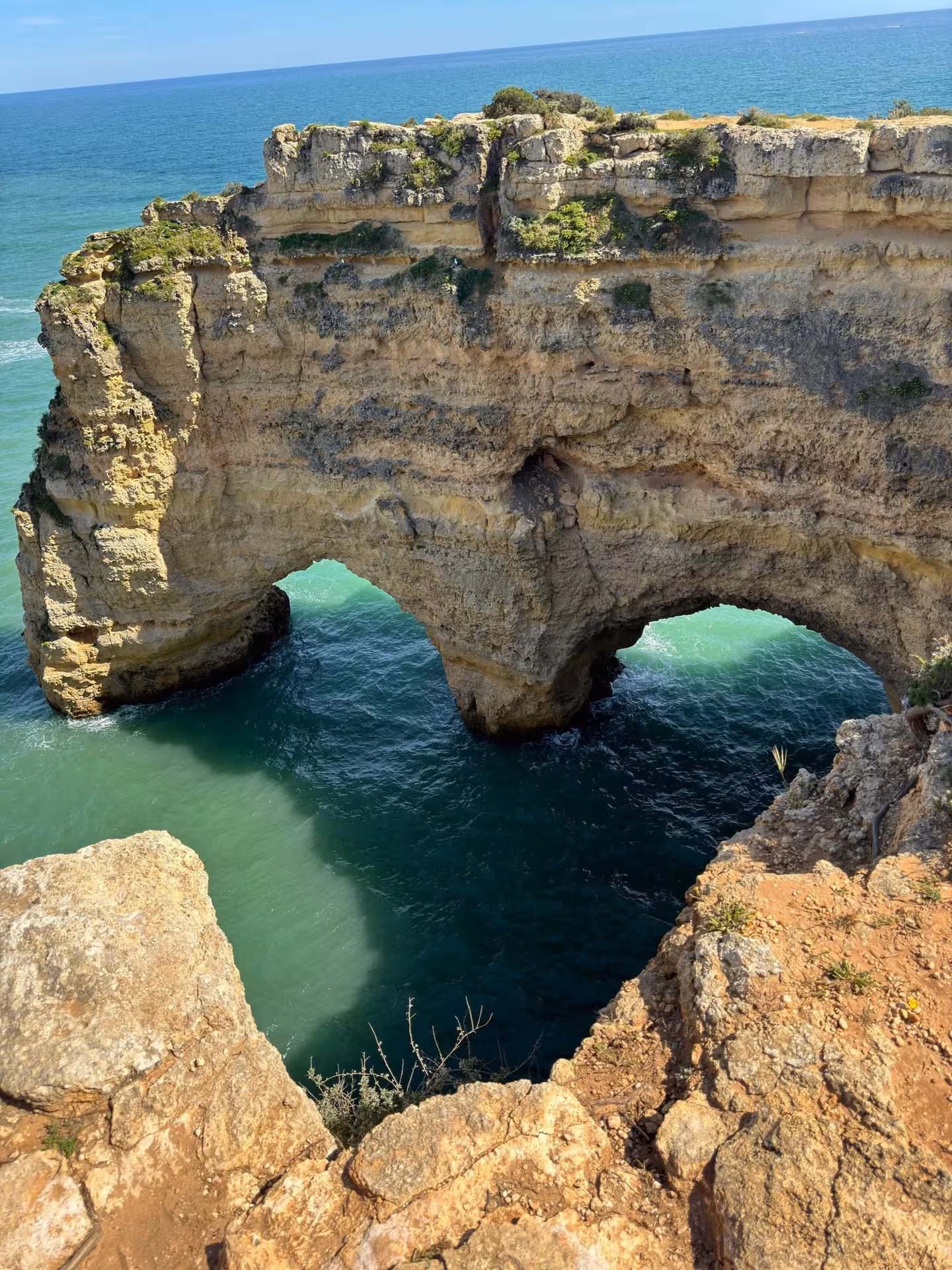 Dramatic limestone sea arch and cliffs above emerald Atlantic waters on the Benagil & Dolphins coastal tour in Algarve