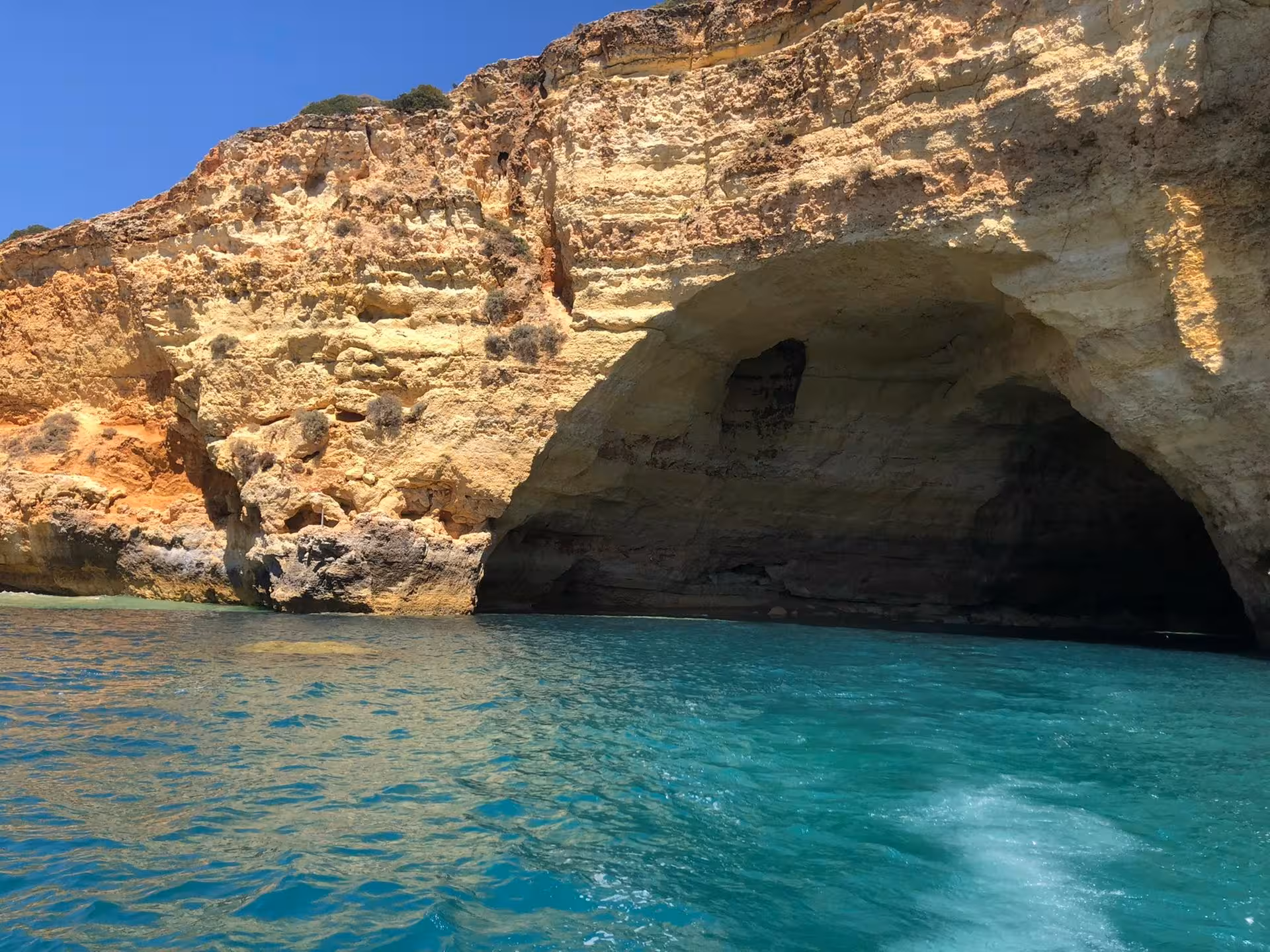 Close-up view of the impressive cliffs and azure waters at Marinha Beach, a highlight of the Algarve coastline.
