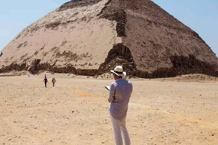 Traveler views the Bent Pyramid at Dahshur, Egypt, on a Dahshur Pyramid and Memphis City tour from Cairo