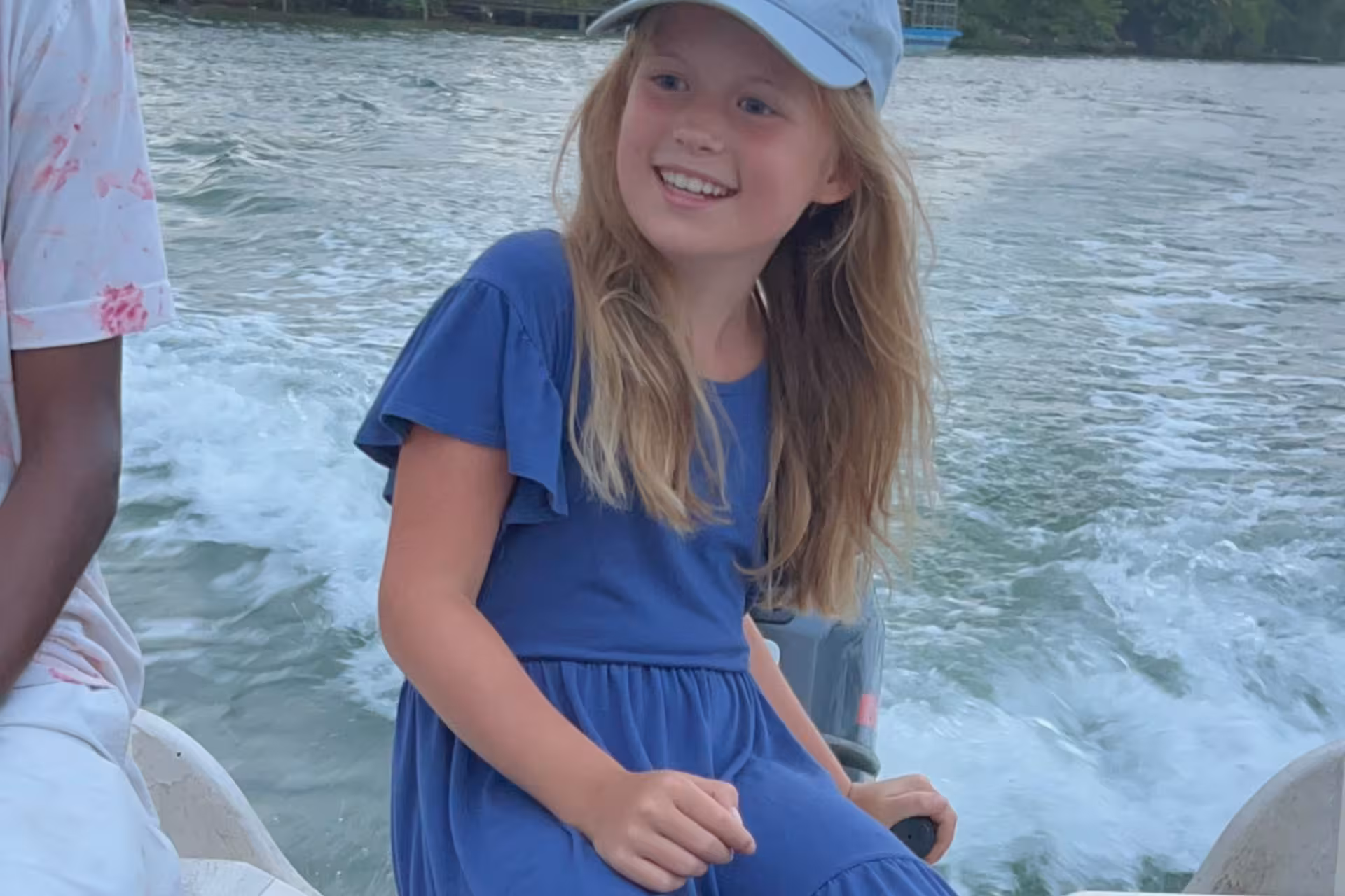 Smiling child on speedboat ride in Bentota River Safari, Sri Lanka, cruising past mangroves and wildlife