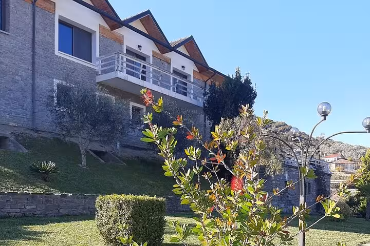 Charming vineyard estate with manicured gardens featured in the Berat 4x4 off-road wine tasting tour.