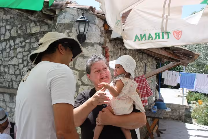 A joyful interaction between tourists and locals during a day trip to Berat, showcasing Albanian hospitality.