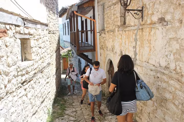 Tourists exploring the narrow cobblestone streets of Berat during a guided historical walking tour.