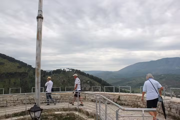 Tourists enjoying panoramic views from a historical site during a walking tour in Berat, Albania.