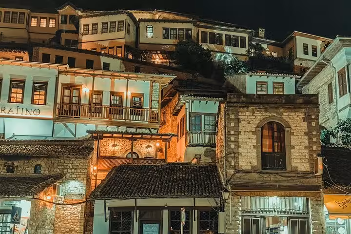 Charming night view of traditional Ottoman houses in Berat, Albania, featured on the Best of Albania in 4 Days tour.