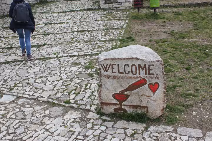 Stone path in Berat with welcome sign, perfect for a premium walking tour experience with expert guides.