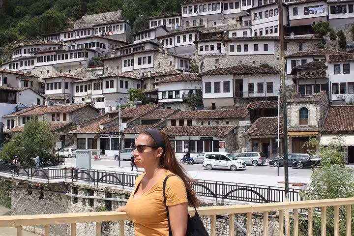 Visitor exploring the historic hillside architecture of Berat, Albania, on a scenic wine tasting and food tour.