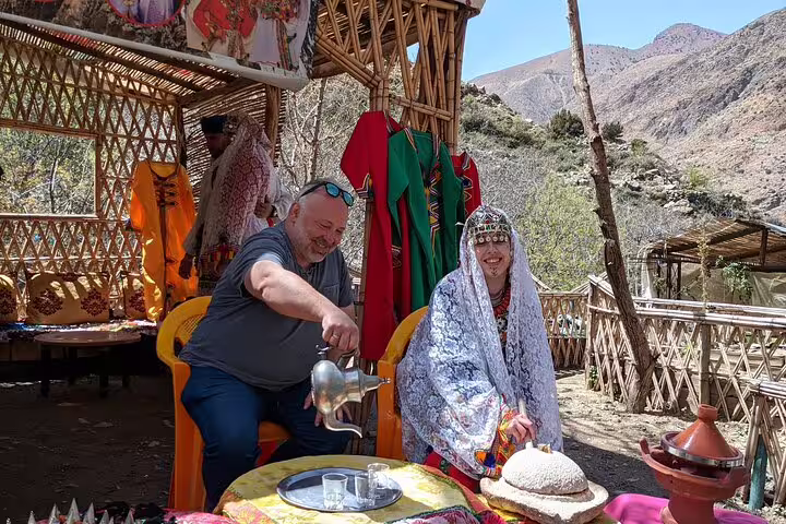 Tourists enjoying Berber tea ceremony in Ourika Valley, Atlas Mountains day trip with village cultural experience