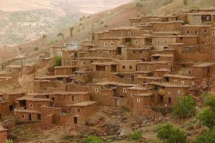 Traditional Berber village of mud-brick homes on Atlas Mountains hillside, Ourika Valley day trip