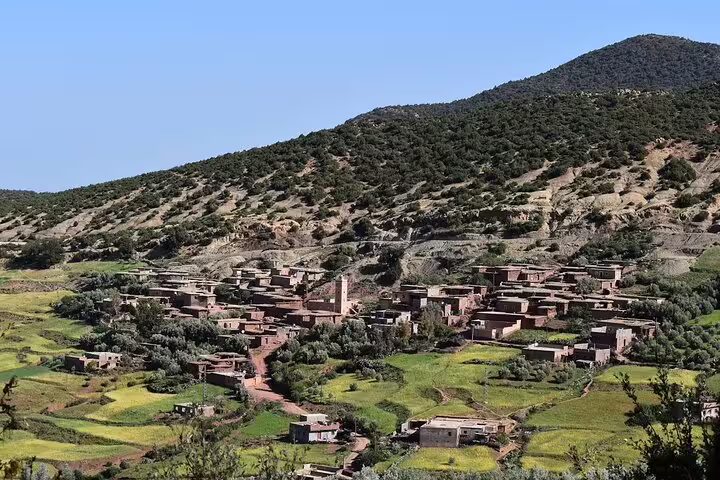 Berber village in the Ourika Valley with terraced fields and Atlas foothills, Marrakech day trip countryside view