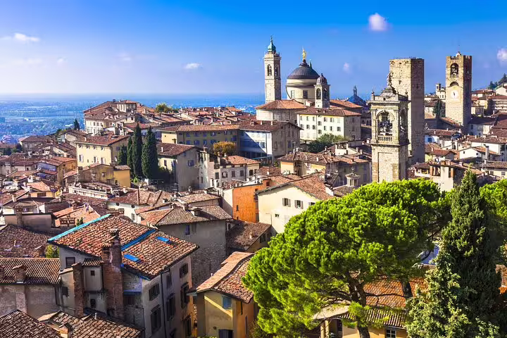 Panoramic view of Bergamo Alta rooftops, medieval towers and Duomo seen on a sunny 2.5-hour private walking tour in Italy