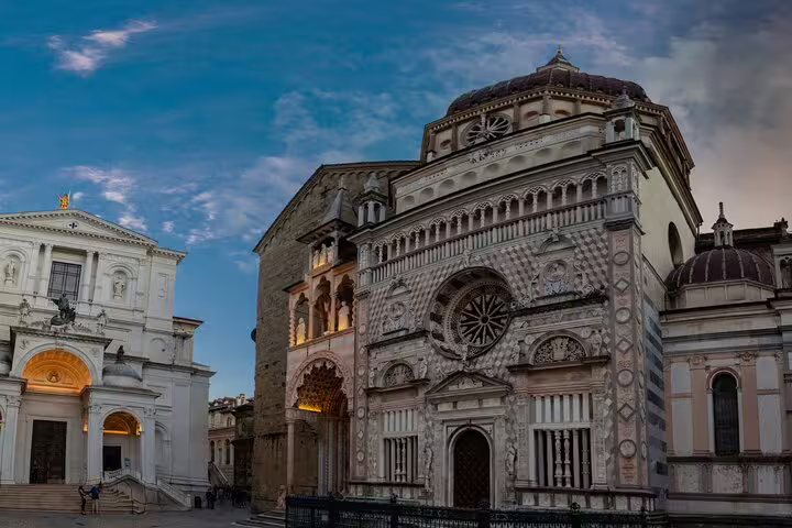 Facade of Bergamo Cathedral and Piazza Duomo at dusk, featured on the Bergamo Old Town scavenger hunt tour