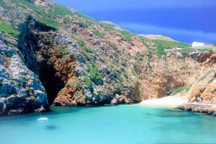 Stunning Berlengas Island cove with turquoise waters and rugged cliffs, perfect for a private day tour from Lisbon.