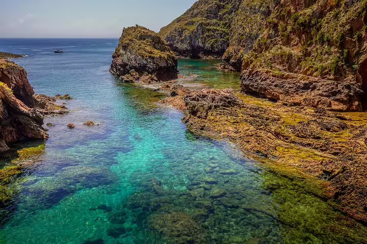 Crystal-clear turquoise waters and rugged cliffs of Berlengas Island, perfect for a private full-day tour from Lisbon.