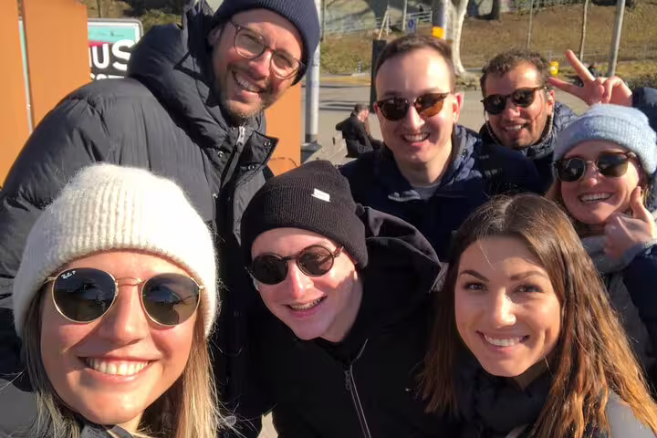 Group selfie during Bern scavenger hunt and sights self-guided tour, smiling in sunny Old Town Switzerland