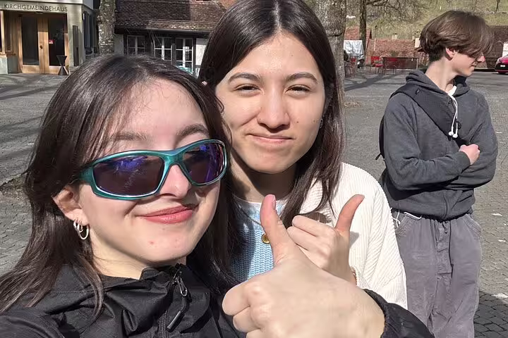 Happy travelers selfie in Bern, Switzerland, during a self-guided scavenger hunt walking tour adventure