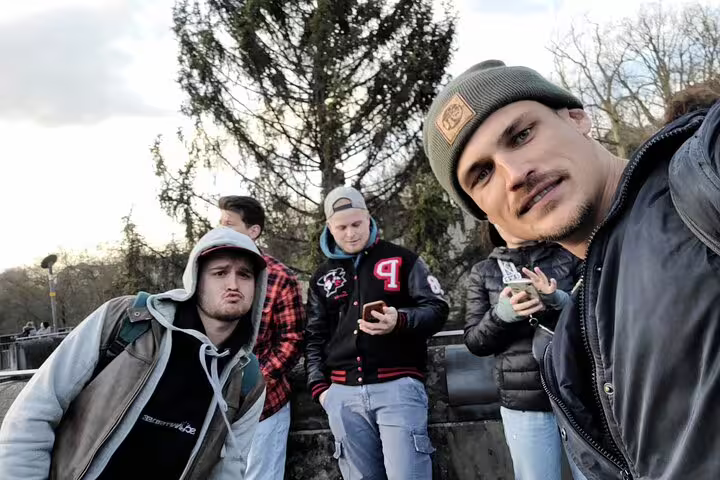 Participants on Bern self-guided scavenger hunt tour checking phones for clues near scenic city viewpoints