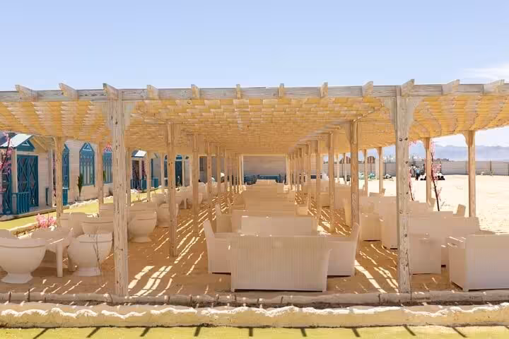 Shaded pergola lounge seating on Bianca Island beach, relaxing break during Utopia Island day trip from Hurghada