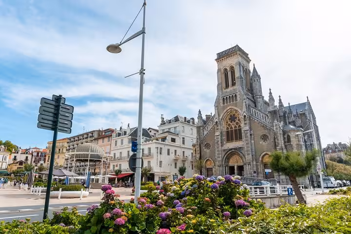 Historic church with vibrant flowers in Biarritz, highlighting architectural charm on a private city walking tour.