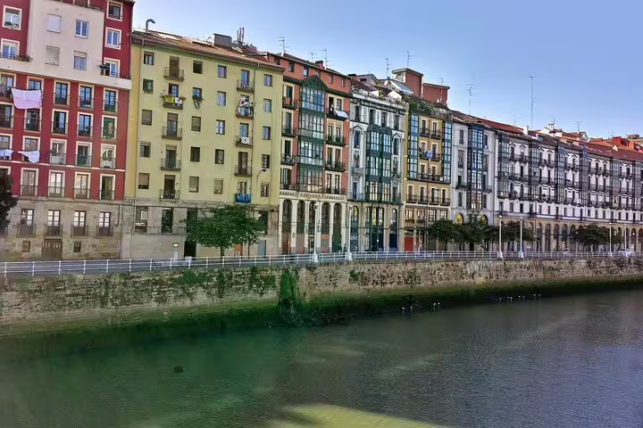 Colorful riverside buildings along the Nervión River in Bilbao, landmark view for a self-guided e-scavenger hunt