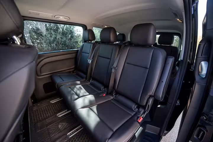 Spacious black leather van seats for Athens to Corinth Epidaurus Nafplio full-day private tour transfer