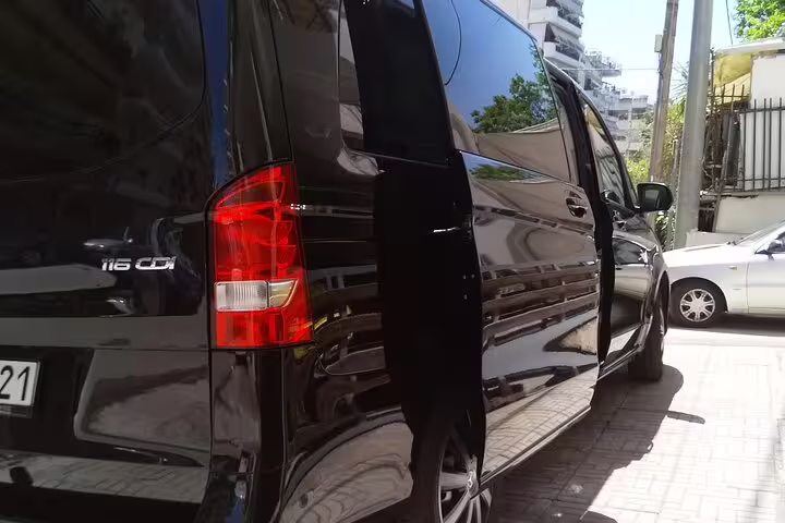 Black luxury Mercedes van with sliding door open, private Athens Airport limousine transfer to Plaka Monastiraki