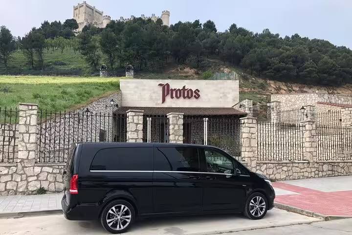Black minivan private transportation to Ribera del Duero at Protos winery in Peñafiel for wine tasting tours