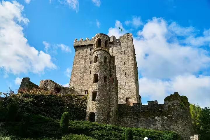 Blarney Castle stone tower in County Cork under blue skies, key stop on the Dublin to Cork City day trip