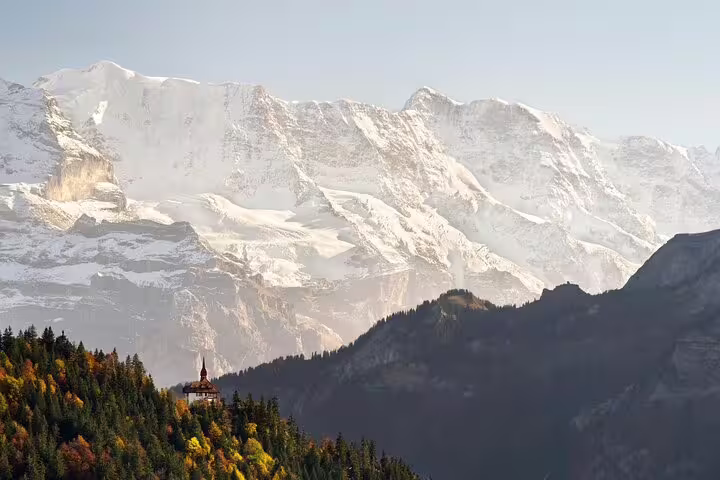 Scenic view of snow-capped mountains and lush forests near Interlaken on the Blausee Lake private tour.