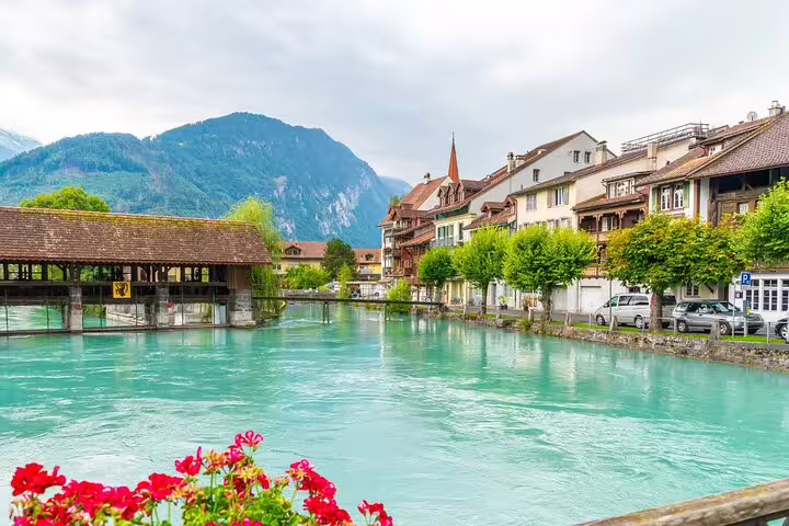 Charming Interlaken village by turquoise river, offering scenic views on the Blausee Lake and Interlaken tour.