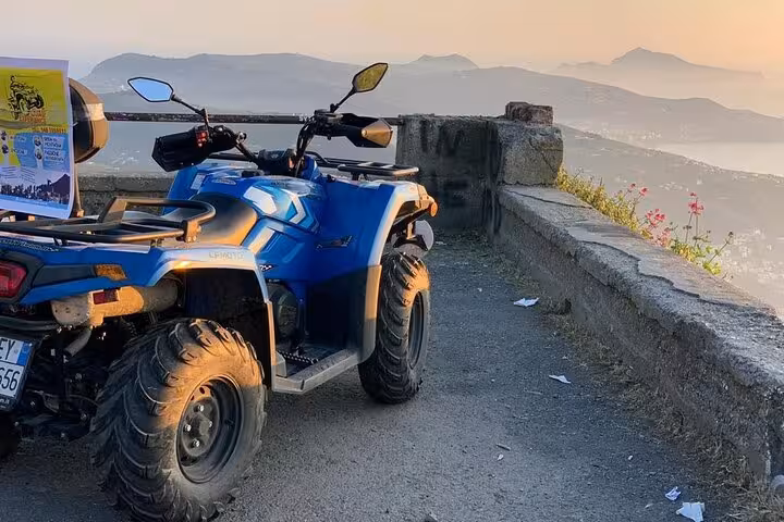 Blue ATV parked with stunning panoramic views of Mount Faito, offering a perfect stop during the quad adventure.