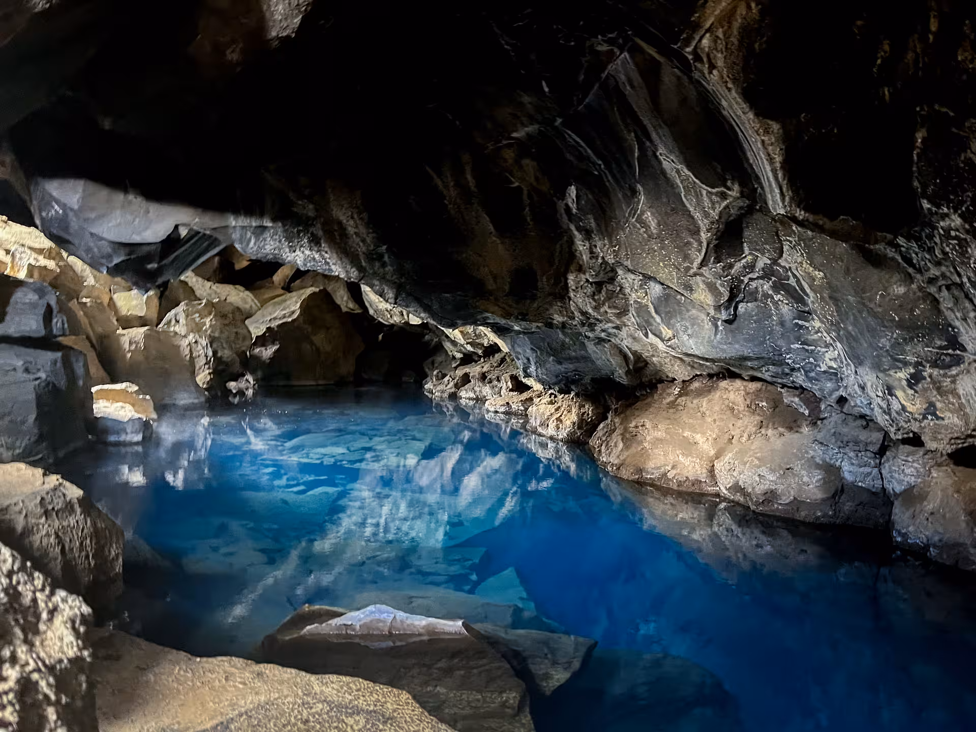 Blue geothermal cave pool in North Iceland, a natural stop on Akureyri port tour to Lake Mývatn and Goðafoss