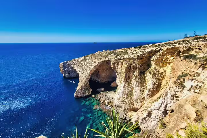 Blue Grotto Malta sea cliffs and natural arch over crystal-clear water, scenic stop on private half-day tour