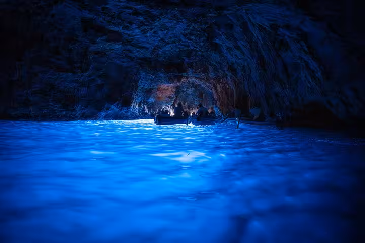 Explore the mesmerizing Blue Grotto with its glowing azure waters on a guided tour from Naples.