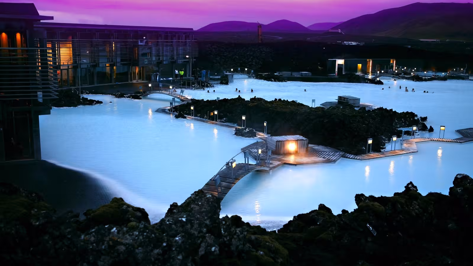 Blue Lagoon geothermal spa at dusk with milky blue water and boardwalks, ideal stop on Reykjavik transfer
