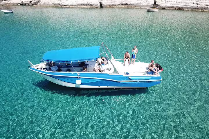 Blue Lagoon & 3 Islands speedboat tour boat cruising over clear turquoise water near Comino, Malta