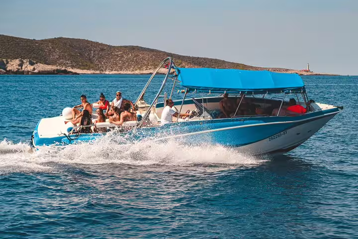 Blue Lagoon & 3 Islands speedboat tour boat cruising fast on turquoise sea with passengers and island views