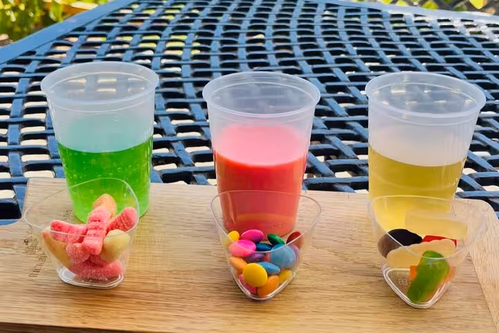 Savor colorful drinks and sweets during the Blue Line Franschhoek tour, offering a delightful treat for visitors from Cape Town.