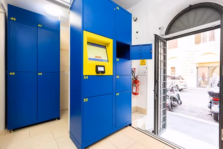 Open blue locker in Rome's luggage storage facility, offering secure and accessible space for travelers' belongings.
