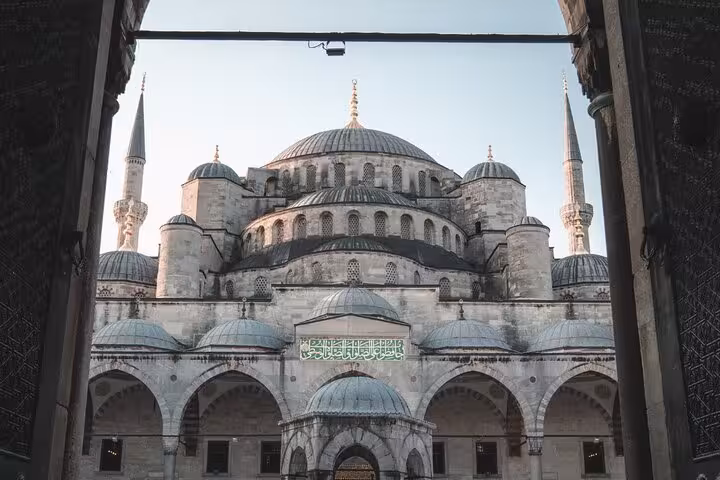 Blue Mosque (Sultanahmet) domes and minarets framed by courtyard arch on a private Istanbul tour