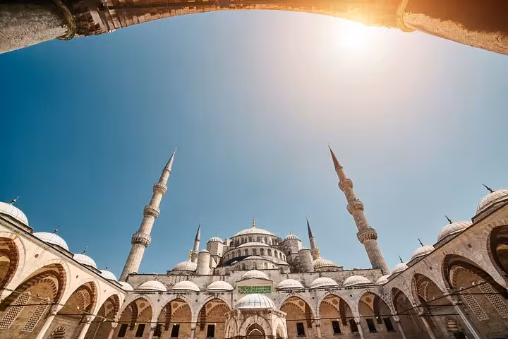 Blue Mosque courtyard and minarets under clear sky, key stop on a 2-day private guided Istanbul tour