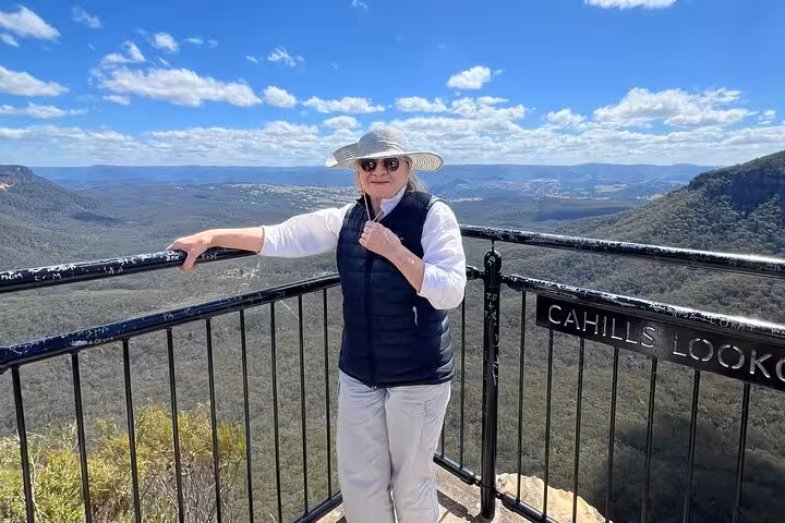 Visitor enjoying panoramic views from Cahills Lookout in Blue Mountains Private Tour, emphasizing natural beauty.