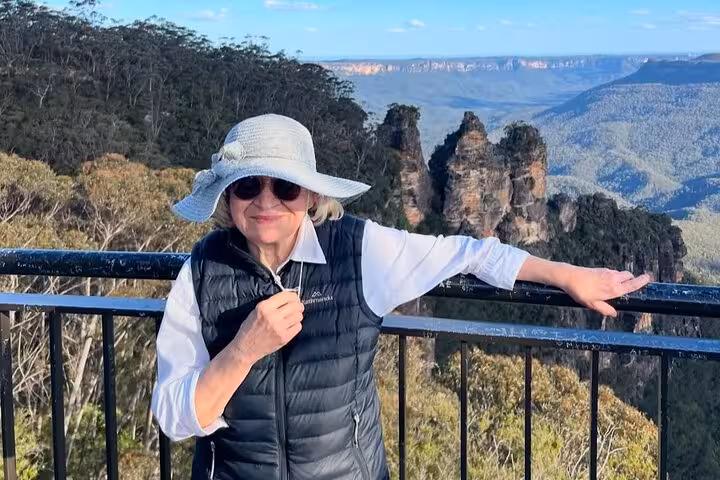 Scenic view of a person enjoying the Blue Mountains backdrop during a private winery tour.