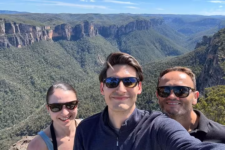 Happy tourists enjoying stunning Blue Mountains vistas, a highlight of the winery tasting private tour experience.